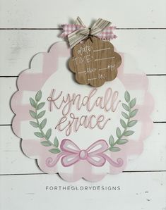 a sign that says kynda all grace with a pink bow on the front and side