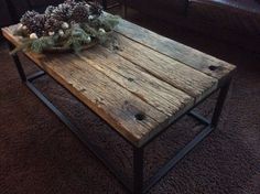 a wooden table with pine cones on top in front of a brown couch and chair