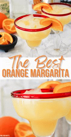 two glasses filled with orange margaritas sitting on top of a table next to an orange slice