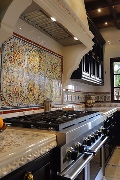 a kitchen with an oven, stove and counter tops in the center is decorated with colorful tiles