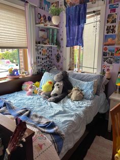 there is a bed with stuffed animals on it