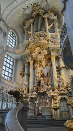 an ornately decorated organ in the middle of a building with stairs leading up to it