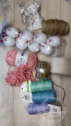 yarn, twine and other crafting supplies laid out on a wooden floor together