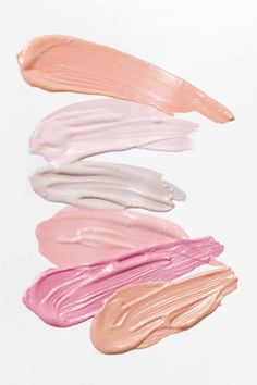 five different shades of liquid lipstick on white background with copy space in the bottom right corner