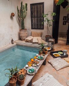 an indoor hot tub filled with food and potted plants