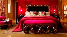 a bedroom with red walls and gold accents