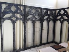 a room divider made out of metal and glass with an intricate design on it