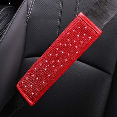 a red seat belt in the back of a car with sparkling stars on it,