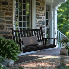 a porch swing with pillows on it