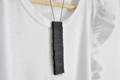 TOTEM necklace is composed of perforated slate strips and plastic-coated steel cable.  It is a necklace with a minimalist and contemporary design, one of a kind! Total black! Entirely handmade in Italy.  The slate, which comes from the waste processing of companies in the province of Genoa, is recovered, recycled and worked again. This type of work, totally handmade, means that my creations are always different from each other.  ✔ Dimensions TOTEM necklace measures 32 cm cm long and weighs about Totem Necklace, Aluminum Earrings, Popular Necklaces, Unusual Necklace, Contemporary Necklace, Alternative Jewelry, Statement Bib Necklace, African Necklace, Art Necklaces