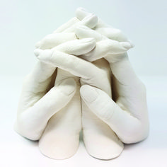 a pile of white pillows sitting on top of each other in front of a white background