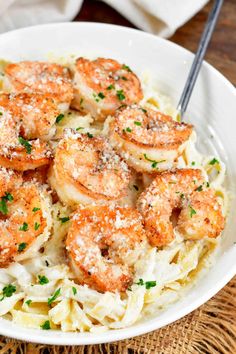 pasta with shrimp and parmesan cheese in a white bowl