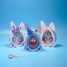 three easter eggs with bunny ears and bows are in the shape of an egg carton