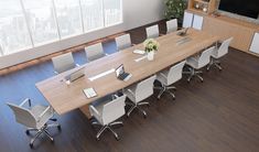 a large conference table with white chairs in an office setting, overlooking the cityscape