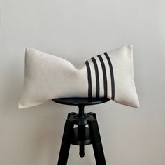 a black and white pillow sitting on top of a chair