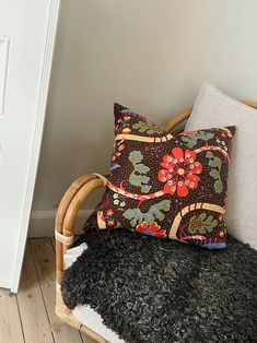 a chair with a pillow on it next to a door