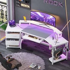 a computer desk with a purple light on it