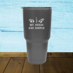 a blue tumbler cup with the words mermaid life on it sitting on a wooden floor