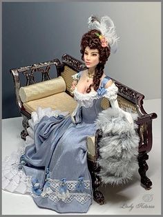 a doll is sitting on a chair with a dog