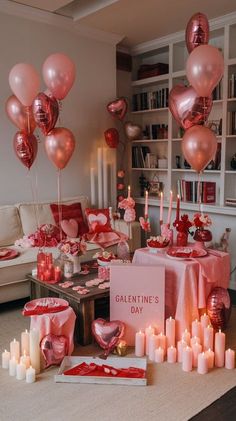 a living room filled with lots of pink and red balloons