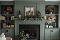 a living room filled with furniture and a fire place in front of a wall mounted fireplace