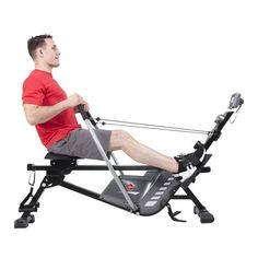 a man is sitting on a rowing machine