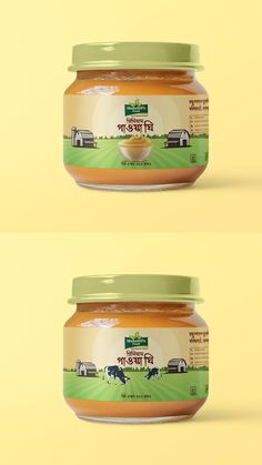 two jars of peanut butter sitting next to each other on top of a yellow background