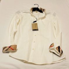 Authentic Burberry White Long Sleeve Button-Down Shirt. Size Xs. Slim Fit With Tag Attached Made In Thailand 97% Cotton 3% Elastane Posh Will Authenticate. Buy With Confidence Burberry Tops, White Brand, Shirt White, White Long Sleeve, Button Downs, Burberry, Button Down Shirt, Thailand, Slim Fit