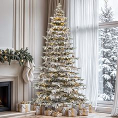 a white christmas tree with presents under it