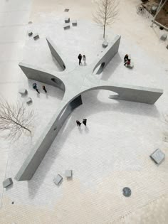 an aerial view of people walking around a sculpture