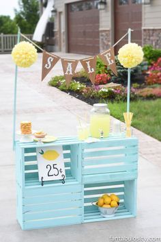 a small blue cart with lemons and drinks on it