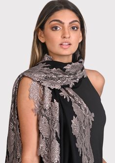 This black scarf is an all time classic with a little bling. Woven from a fine silk and wool blend, it features a contrasting Antique Silver floral lace border making for the perfect any time wear accessory whilst keeping you comfortably warm. For a casual or formal look, this is a must-have in every woman's wardrobe. Elegant Black Scarf For Festive Season, Elegant Black Scarves For Festive Season, Elegant Black Shawl For Festive Occasions, Elegant Black Festive Shawl, Elegant Black Festive Scarves, Silk Dupatta For Evening, Elegant Black Shawl Dupatta, Black Formal Shawl For Festive Occasions, Elegant Fitted Shawl Dupatta