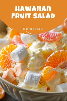 a bowl full of fruit salad with marshmallows and orange slices on top