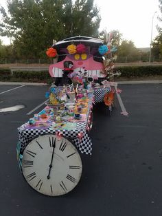 a table with a clock on it in the middle of a parking lot