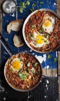 three fried eggs are in a skillet on the stove