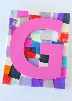 the letter g is made out of colored paper