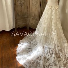 a wedding dress is displayed on a mannequin in front of a door with curtains