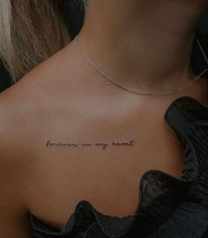 the back of a woman's neck with an inscription that reads, forever is my heart