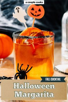 a halloween cocktail with an orange drink in it