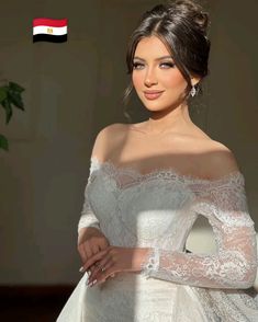 a woman in a white wedding dress posing for the camera with her hands on her hips