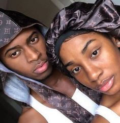 two people are posing for the camera with one wearing a bandana on his head