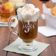 a glass mug filled with ice cream on top of a wooden table