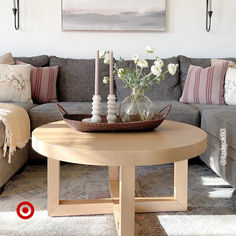 a living room filled with furniture and flowers on top of a coffee table in front of a couch