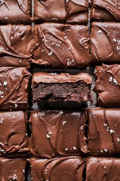 chocolate cake with frosting and sprinkles arranged on a black surface, ready to be eaten