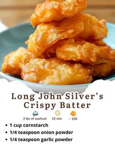 a blue plate topped with lots of food next to a white and black sign that says long john silver's crispy batter