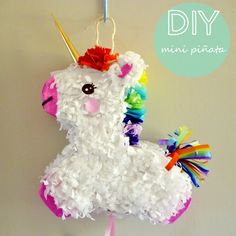 a unicorn pinata hanging on a wall with the words diy written above it