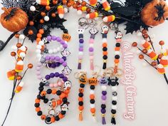 halloween bracelets and keychains are laid out on a white surface with decorations