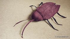 a purple bug sitting on top of a carpet