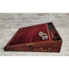 an old wooden desk with two drawers on the top and one drawer open to show items inside