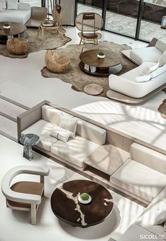 a living room filled with lots of white furniture